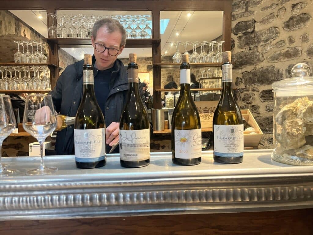 Winemaker in Burgundy answering questions during wine tasting.