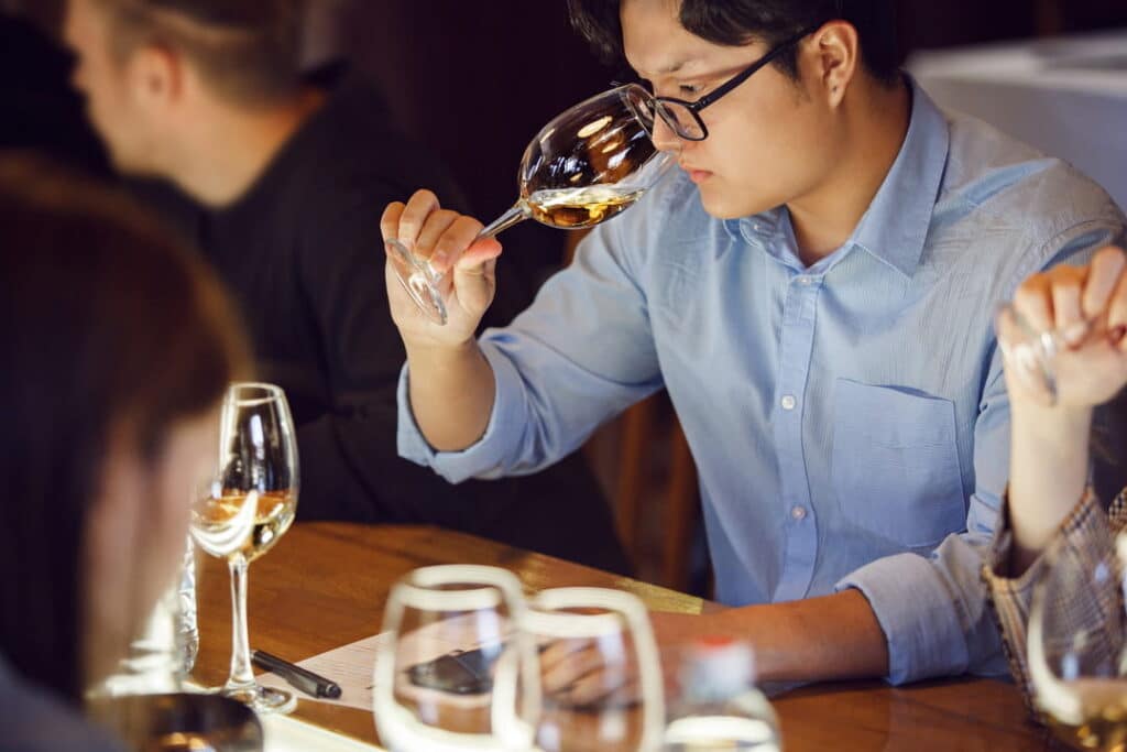 Man smelling wine at a wine tasting.